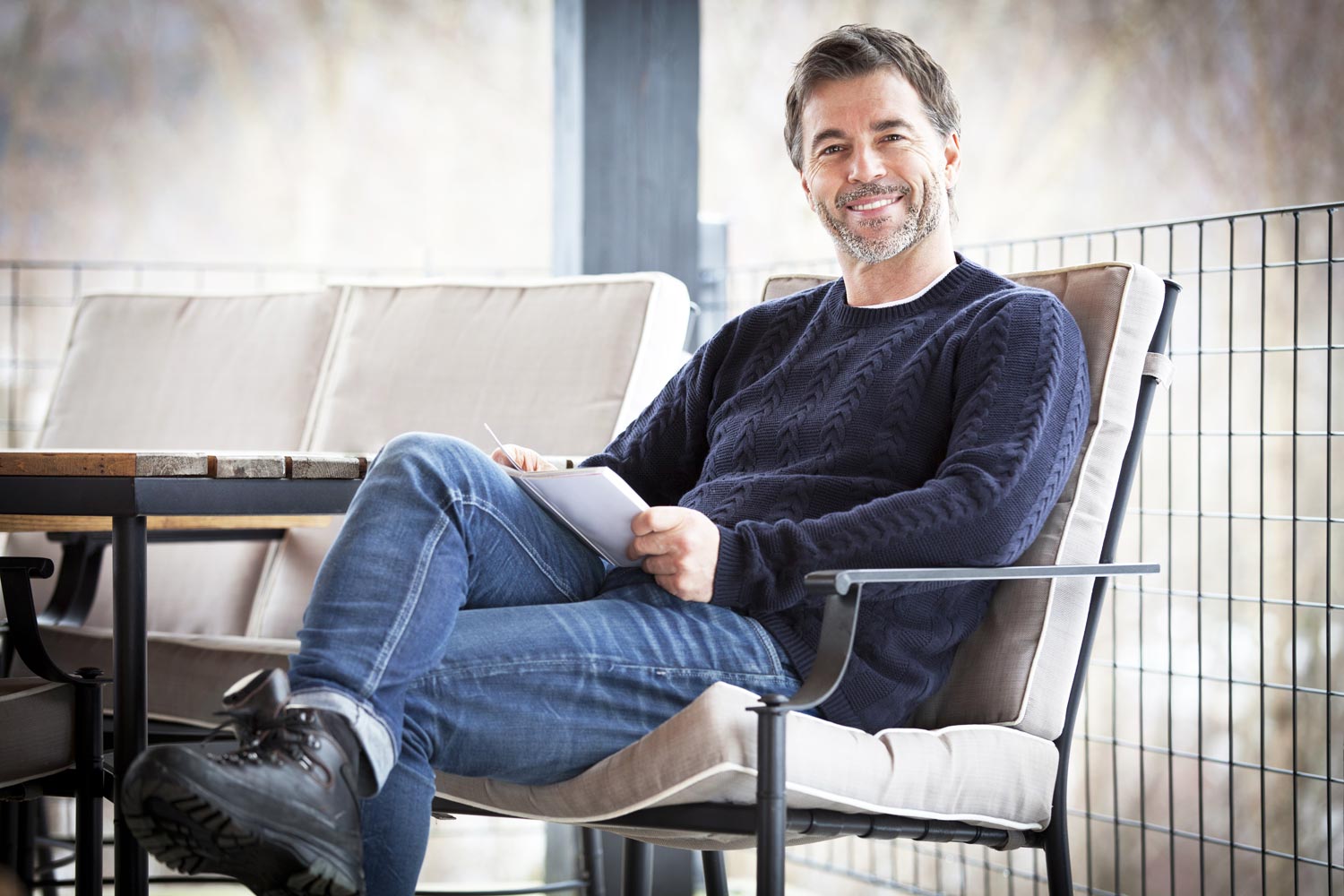 a handsome middle-aged man sitting on a sofa